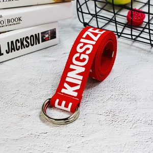 Close-up of red canvas belt with white KINGSIZE print and silver double D-ring buckle