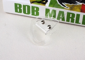 Close-up of a transparent heart-shaped buckle with silver metal rivets on a clear belt