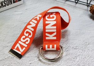 Macro shot of bright orange canvas belt featuring white KINGSIZE text and metal D-rings