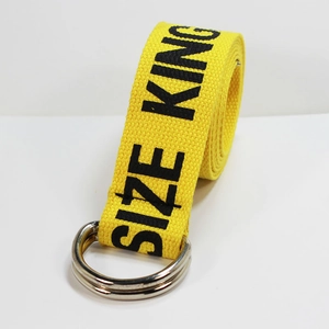 Detail of yellow canvas belt with black SIZE KING print and double D-ring metal buckle