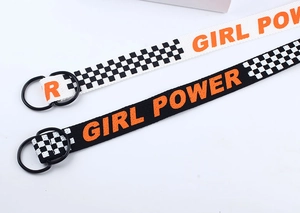 Détail de ceintures en toile à damier avec texte Girl Power et boucles doubles en métal