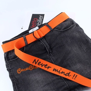 Streetwear grey washed denim with vibrant orange canvas belt featuring bold slogan print