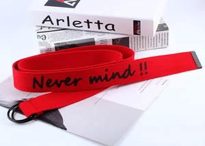 Detail of red canvas belt with double D-ring buckle and Never mind text print