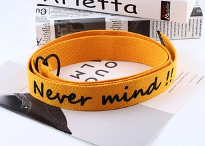 Detail of yellow canvas belt with double D-ring buckle and Never mind text print