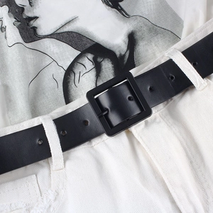 Minimalist black leather belt for women with matte square buckle on white jeans