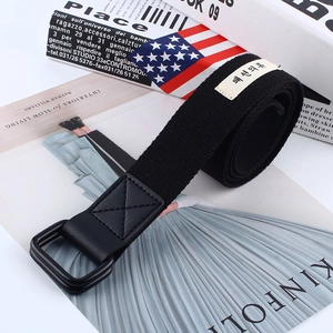 Minimalist black canvas belt with double D-ring metal buckle and woven side label