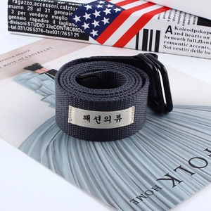Close-up of dark grey woven canvas belt with black double D-ring buckle and fabric label