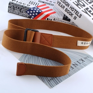 Detail of brown canvas belt with black double D-ring buckle and reinforced leather ends
