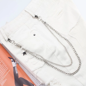Close-up of double-layer silver metal pants chain with star charms on white denim