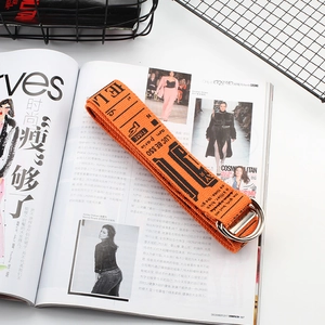Orange canvas industrial belt with black letters and silver double D-ring buckle