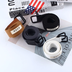 Detail view of colorful canvas belts with metal double D-rings and fabric labels