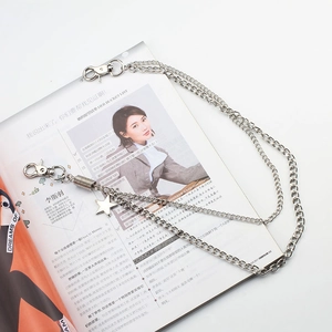 Detail of double-layered silver metal pants chain with star pendant and lobster clasps