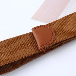 Detail showing the brown woven canvas belt with fine stitching on a leather accent