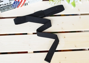 Close-up of black nylon canvas belt with plastic buckle and weave texture detail