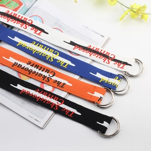 Detail of four colorful canvas belts with double D-ring buckles and street style prints