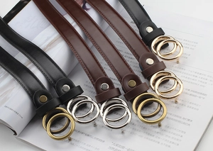 Detail of slim leather belts with double O-ring buckles in black and brown colors
