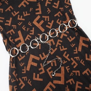 Detailed close-up of a silver metal link waist chain with polished round ring segments