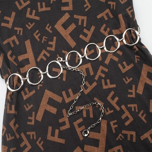 Close-up of a silver metal waist chain featuring polished rings and adjustable link chain
