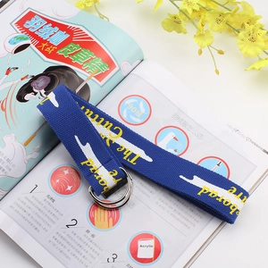 Deep blue canvas belt with double ring buckle and yellow letters on a magazine background