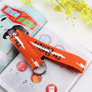 Detail of orange woven belt with Skateboard Culture print and polished metal D-ring buckle