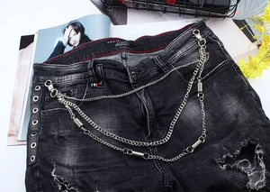Close-up of triple-layered silver metal pants chain with spring charms and lobster clasps