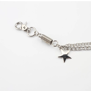 Detail of silver double-layered metal trousers chain with lobster clasp and star pendant