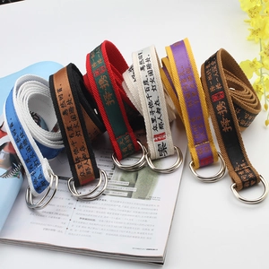 Fashionable nylon canvas belts with double D-ring buckles and Chinese text on a magazine background