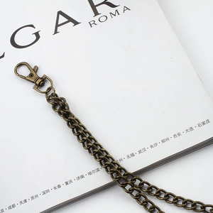 Close-up of bronze metal trousers chain with lobster clasp and twisted link texture