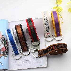 Detail view of canvas belts with double D-ring buckles and Chinese calligraphy patterns