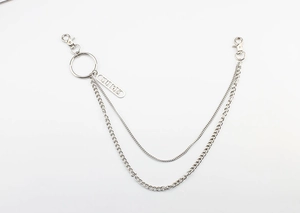 Detail of silver double-layered hip hop pants chain with engraved metal brand tag