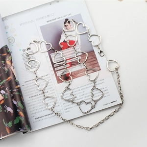 Close-up of silver heart-shaped link waist chain belt with adjustable lobster clasp