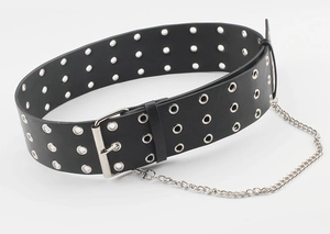 Detail of a punk style wide black belt featuring triple-row silver grommets and a metal chain