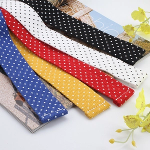 Detailed view of colorful polka dot pattern canvas belts with high-quality stitching