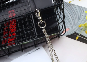 Detailed close-up of double-layer silver metal pants chain with lobster clasp and ring links