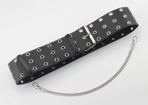 Detail of black punk wide waist belt with triple rows of silver eyelets and metal chain