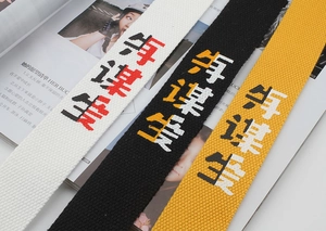 Close-up of thick canvas belts with Chinese character print in white, black, and yellow