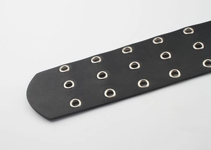 Close-up of black leather punk waist belt with three rows of silver metal eyelets
