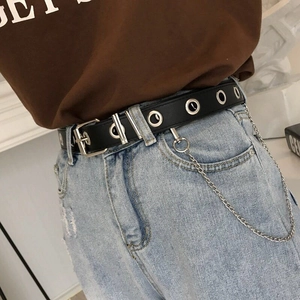 Close-up of black punk leather belt with silver eyelets and detachable chain accessory
