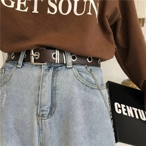 Coffee brown leather punk belt with silver metal eyelets and chain on jeans
