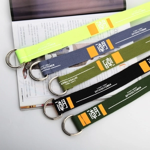 Close-up of multicolored canvas belts with metal double D-ring buckles and text print