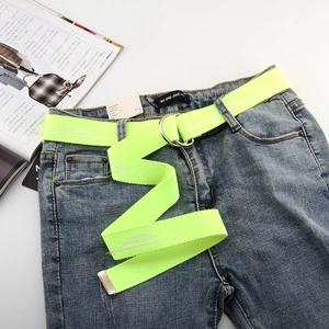 Detail of neon yellow canvas belt with double D-ring buckle and 30TH OCTOBER text print