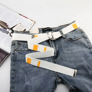 Detail of white canvas belt with orange stripes and silver double D-ring metal buckle