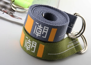 Close-up of canvas belt with metal double D-ring buckle and trendy text printing