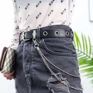 Punk style black PU leather belt with silver grommets and bear chain on denim skirt