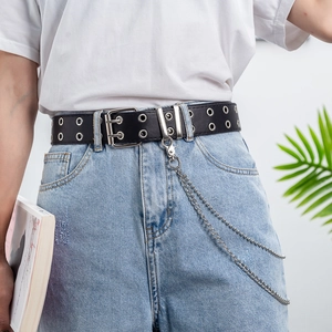 Punk black leather belt with double grommets and detachable silver metal chain on denim