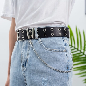 Close-up of punk style black PU leather belt with silver double eyelets and metal chain