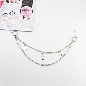 Detail of silver double-layered metal pants chain with clover, cross and star charms