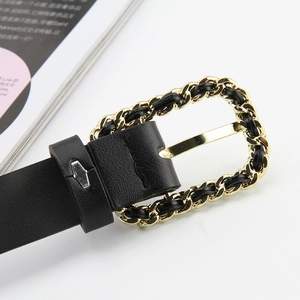 Detail of black leather belt with gold chain buckle and woven leather strip
