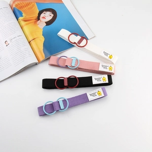 Close-up of canvas belt with metal double ring buckle and cute duck embroidery detail