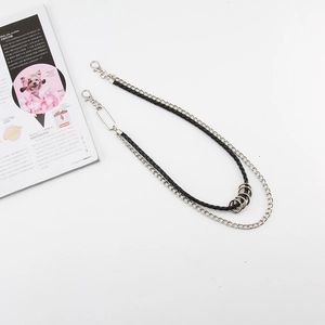 Close-up of double-layer punk trouser chain with silver rings and black leather cord